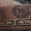 Basic Checkbook
Original by Joni Lund

Item #

Dragon surqounded by Celtic scrolls, Fillagee cut outs with sparkle background in scrolls.
Shades of brown, yellowish cream, red, 
Room for initials or concho of sword, crossed ax, dragon, initials or celtic knot, or pitsh.   Initial or concho $7.00 mor